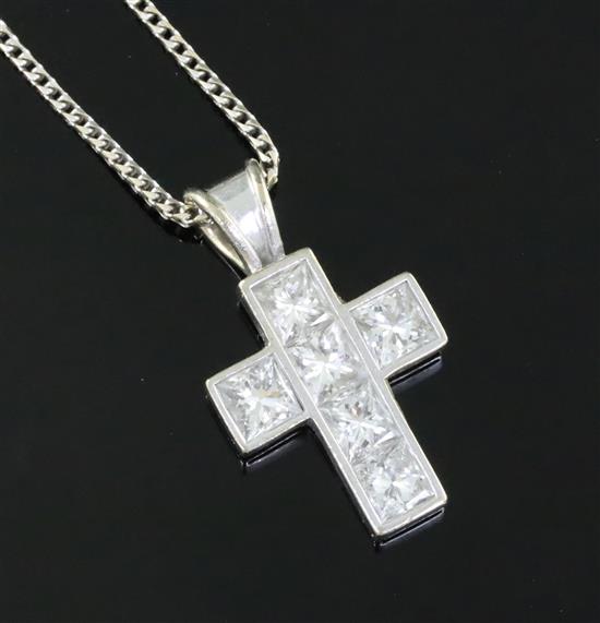 A modern 18ct white gold and six stone Princess cut diamond set cross pendant by Theo Fennell,